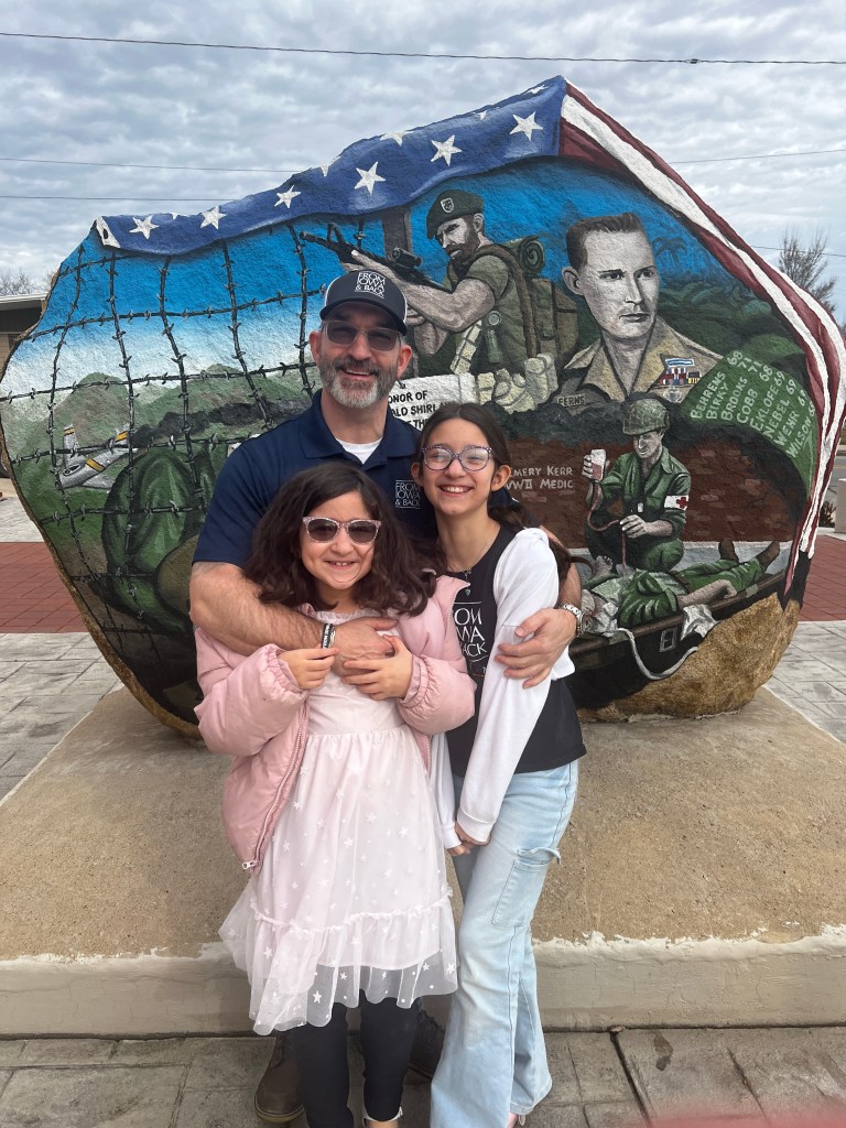 Jeremy Glazier with daughters Jessica and Audrey at the Keokuk County Freedom Rock in What Cheer, Iowa.