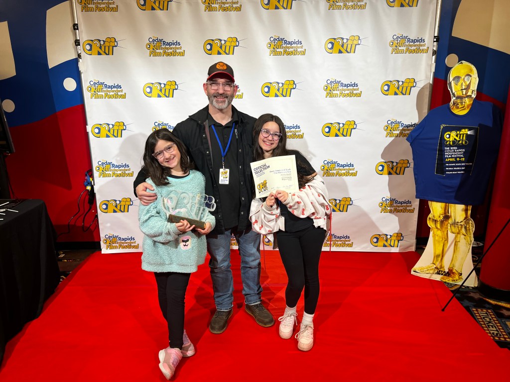 Jeremy Glazier with daughters Jessica and Audrey at the 2026 Cedar Rapids Independent Film Festival after From Iowa and Back received the Professional Documentary award.