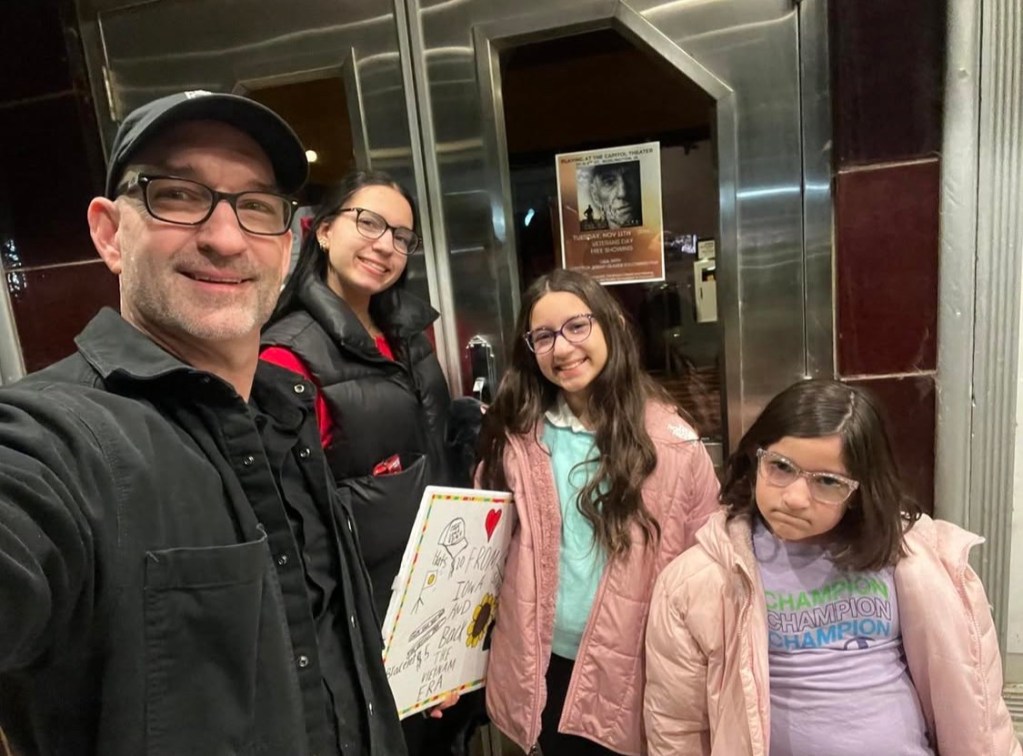 Jeremy Glazier with daughters Allyson, Jessica and Audrey outside the Capitol Theater in Burlington, Iowa, during a From Iowa and Back screening.