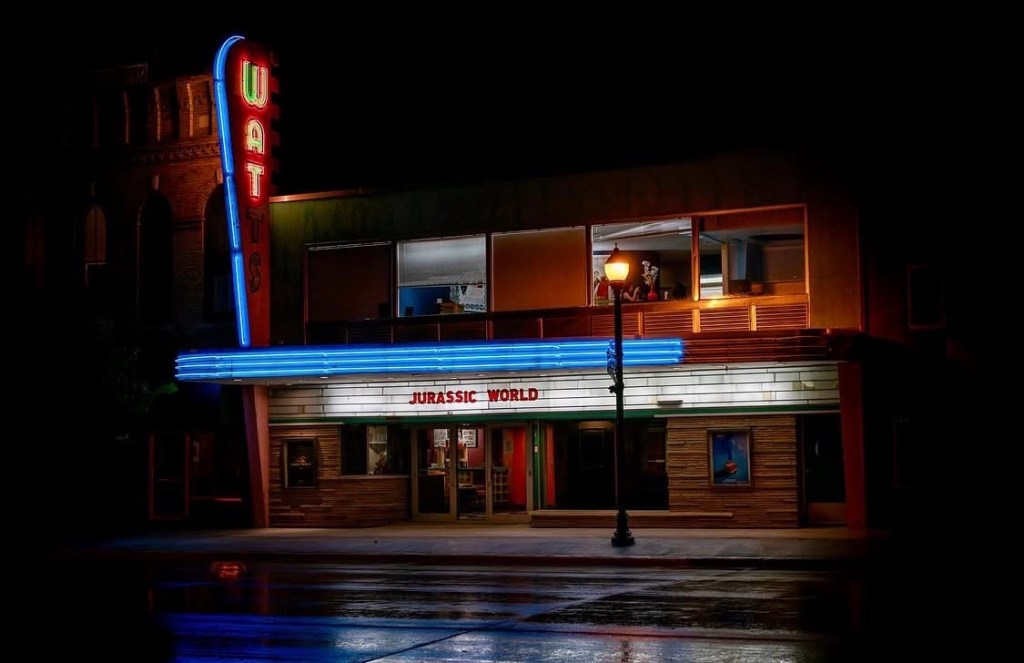 Watts Theatre illuminated at night in downtown Osage, Iowa, photographed by Jeremy Glazier.