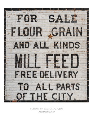 Historic painted flour, grain, and mill feed advertisement on a weathered brick wall in Independence, Iowa.