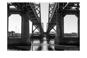 Black-and-white photograph beneath the historic I-74 bridges over the Mississippi River, presented with white margins for a hand-signed Collector's Edition print.